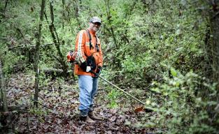 From clearing overgrowth to volunteering with kids, Jason Mendez has opened himself up to helping wherever and whenever he can. Here he clears brush at a Girl Scout camp for Day of Caring.